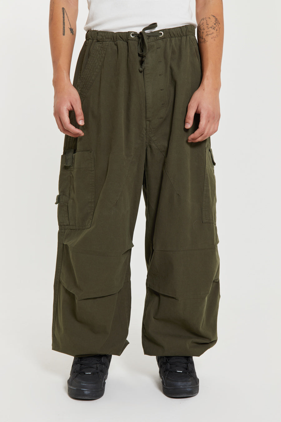 Unisex khaki green oversized fitted parachute style cargo trousers with six pocket styling. 