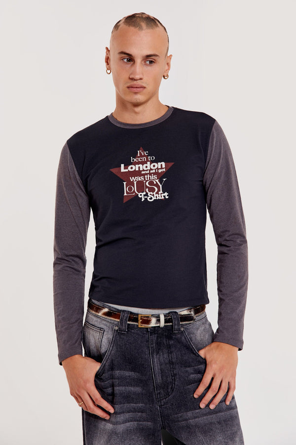 Male wearing black shrunken fit long sleeve tee with printed front. 