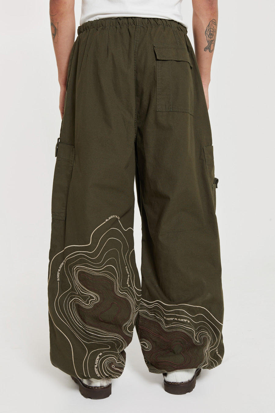 Men's khaki green cargo parachute pants featuring 'Scene' embroidery