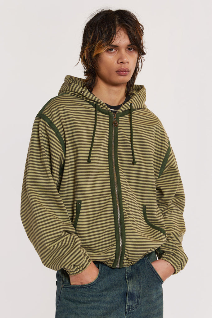 Male model wearing Green Micro Stripe Zip Hoodie . 