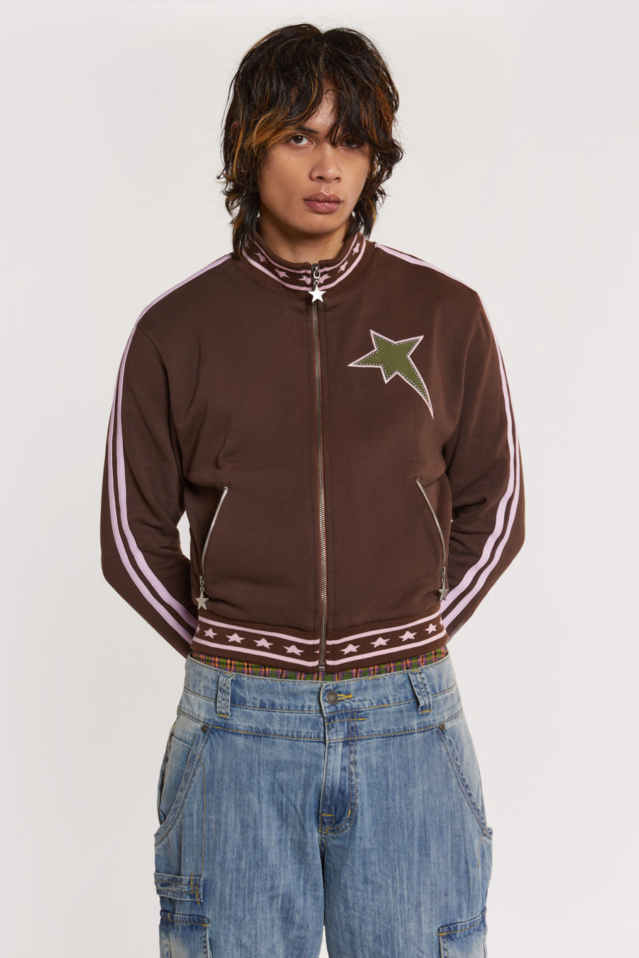 Male model wearing Brown & Pink Track Top with pink stripe detail. 