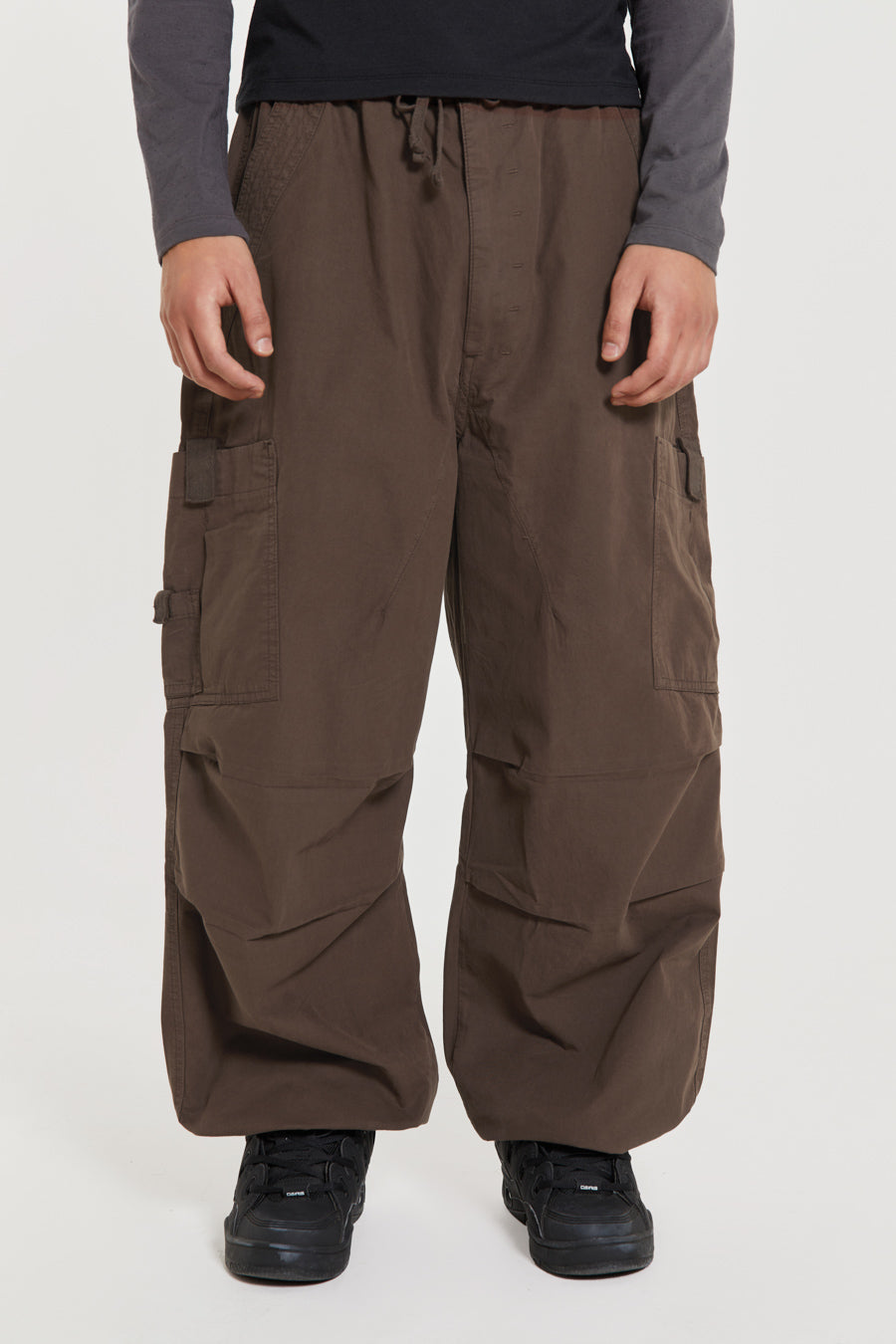 Unisex brown oversized fitted parachute style cargo trousers with six pocket styling. 