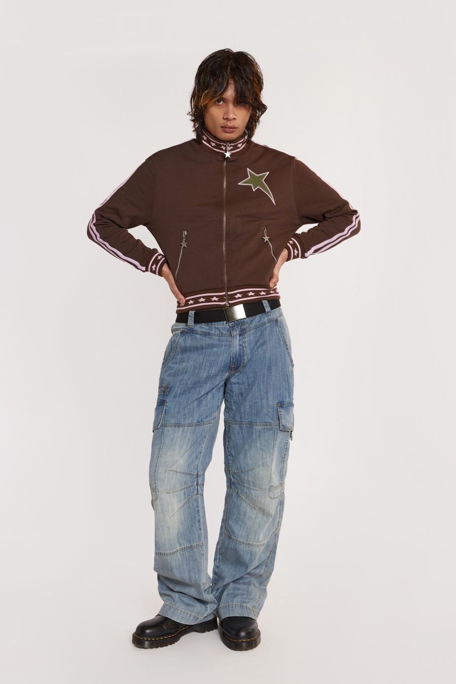 Male model wearing Brown & Pink Track Top with pink stripe detail. 