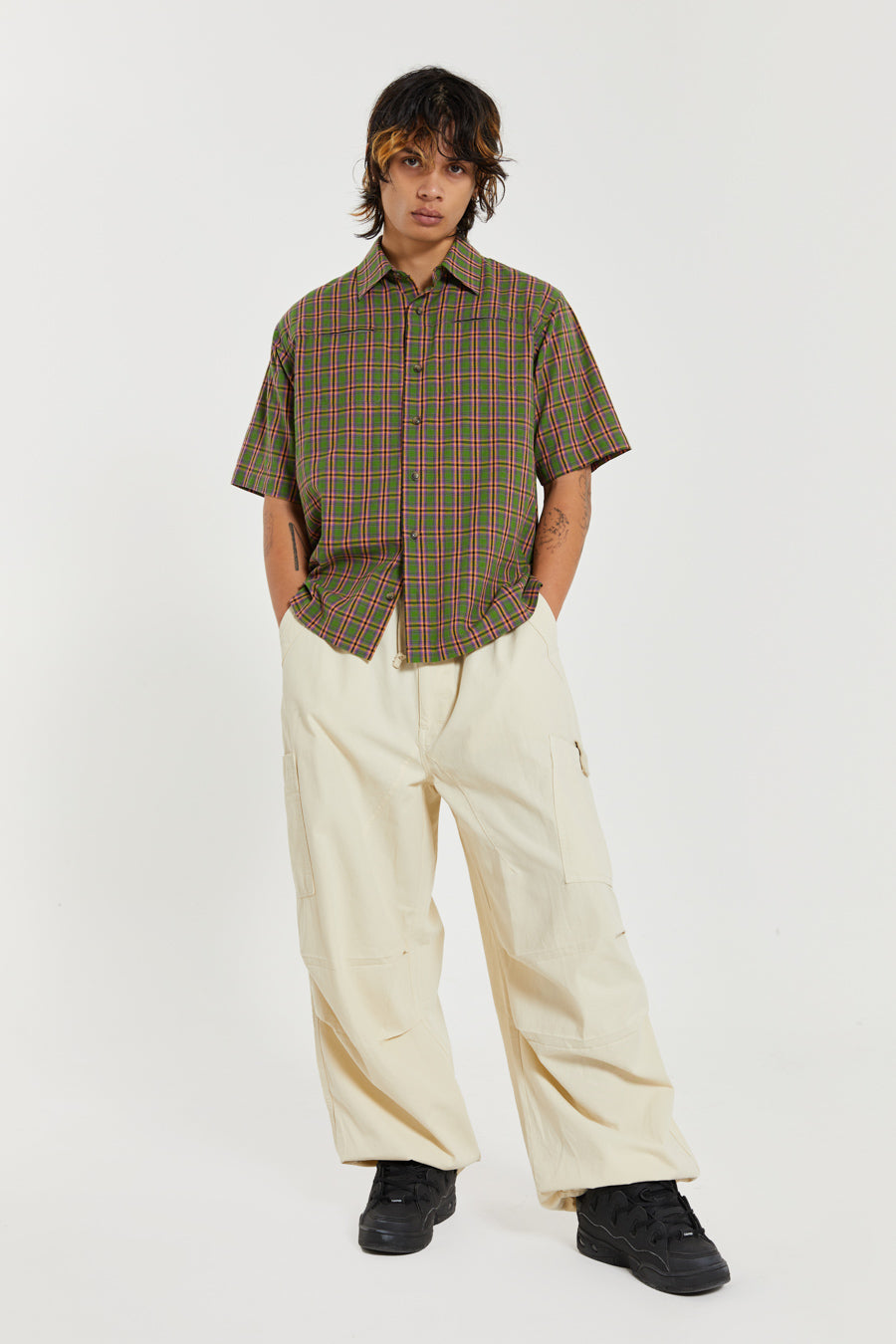 Unisex ecru oversized fitted parachute style cargo trousers with six pocket styling. 