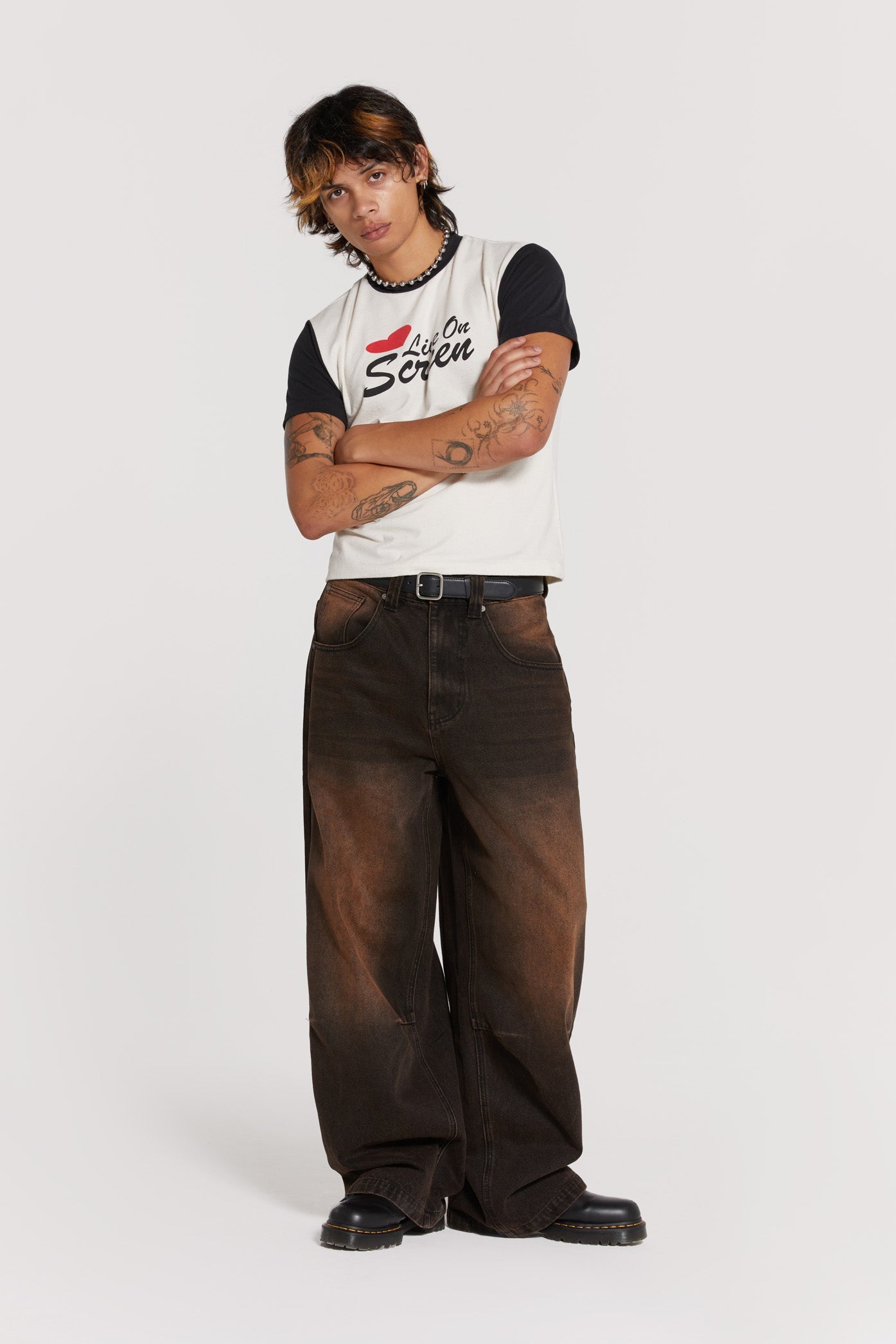 Male wearing vintage brown colossus fit jeans. 