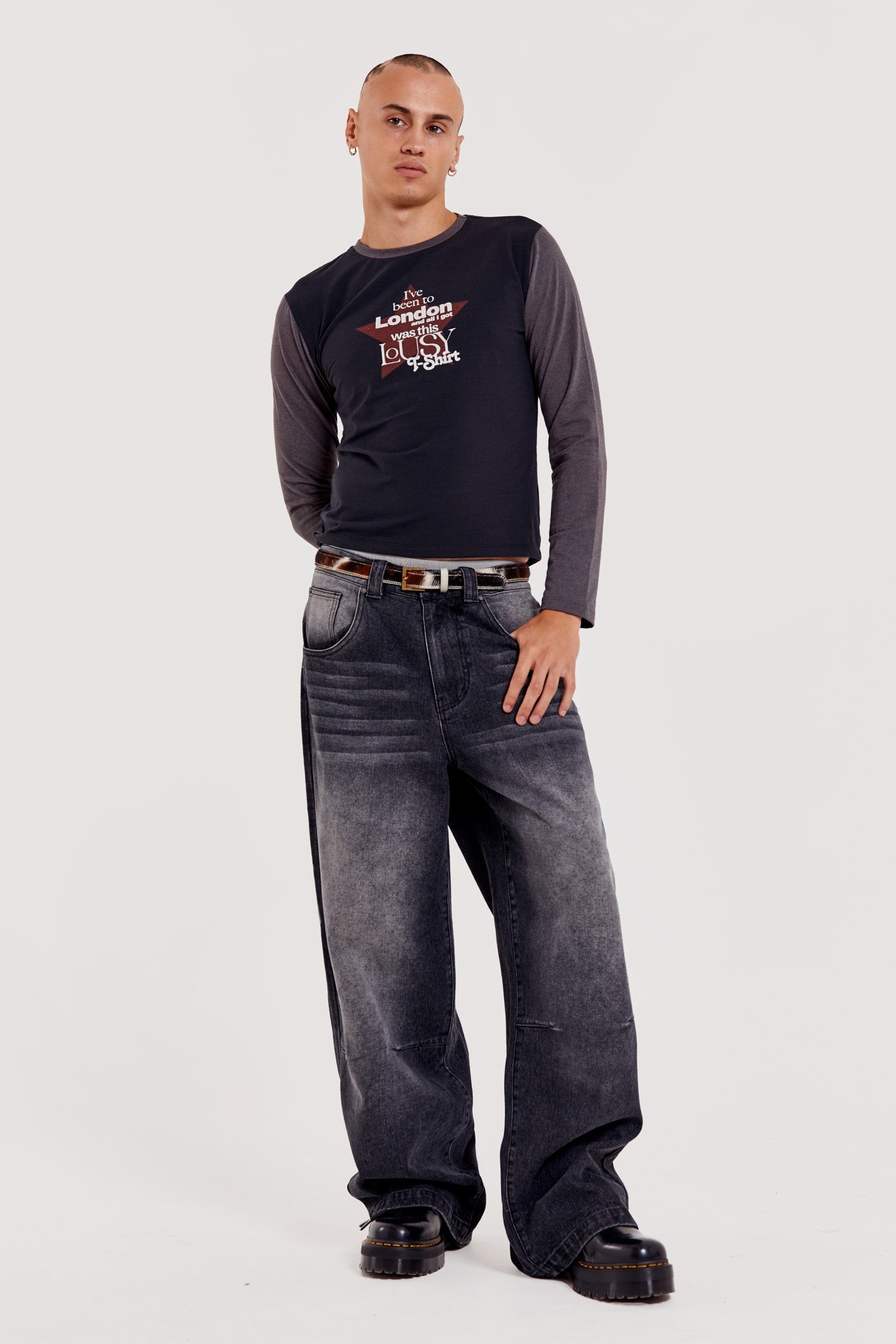 Male wearing washed black colossus fit oversized skate fit denim jeans. 