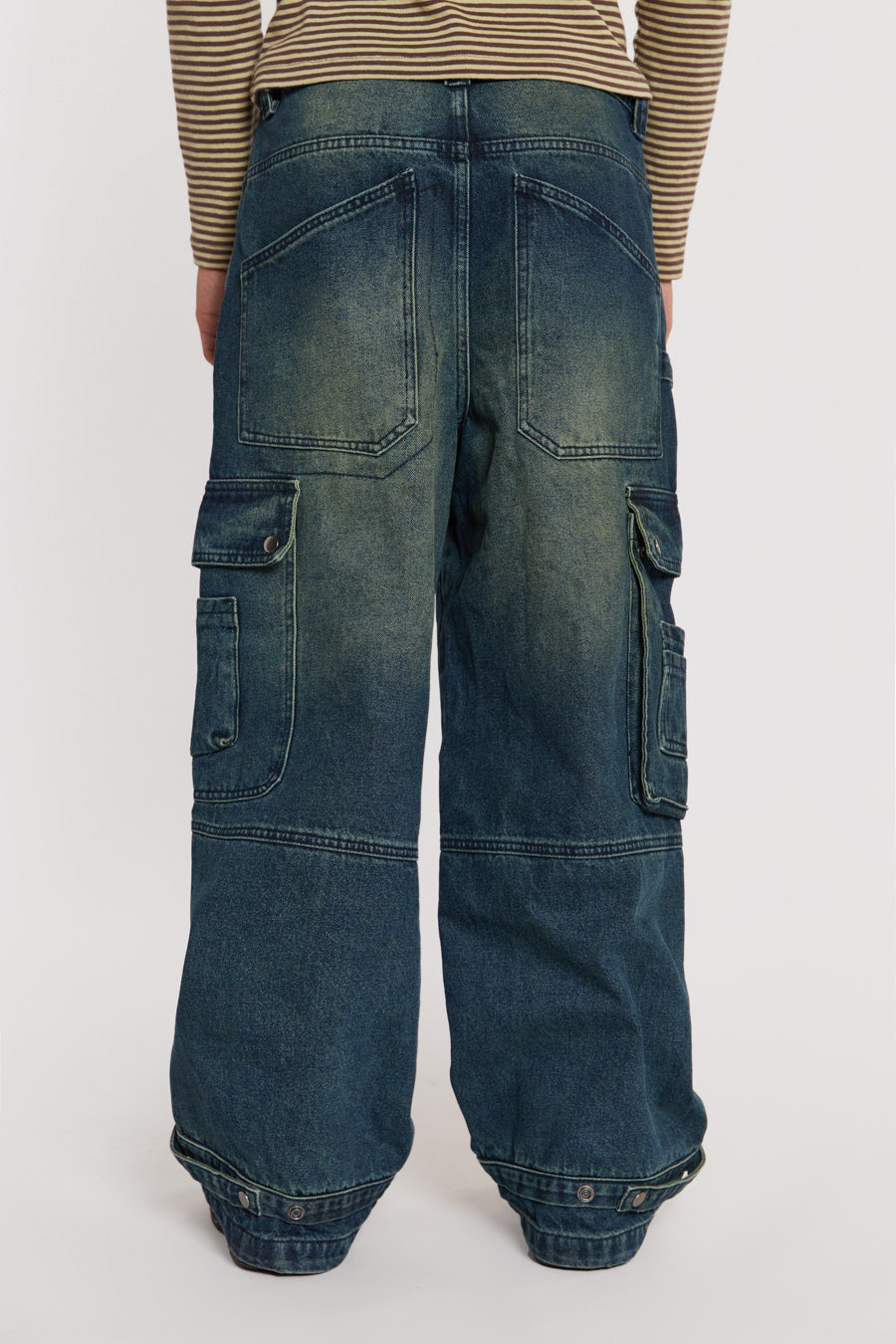 Male model wearing Sandblast Blue Denim Cargo Jeans. 