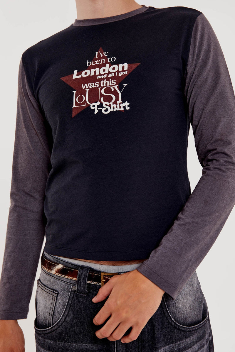 Male wearing black shrunken fit long sleeve tee with printed front. 