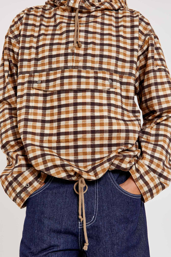 Male wearing brown gingham printed check long sleeved pullover jacket. 