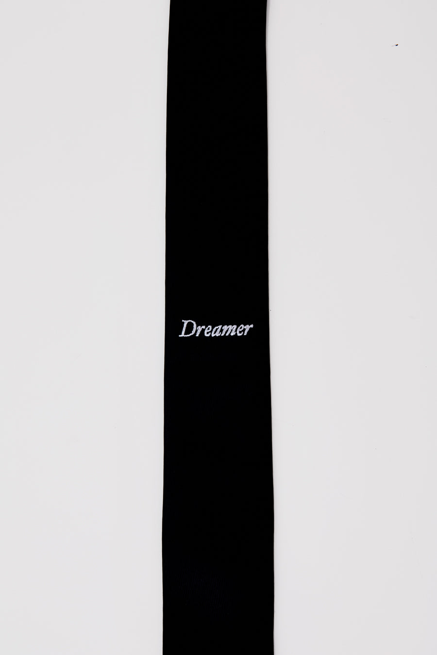 Black tie with white 'Dreamer' embroidery detail. 