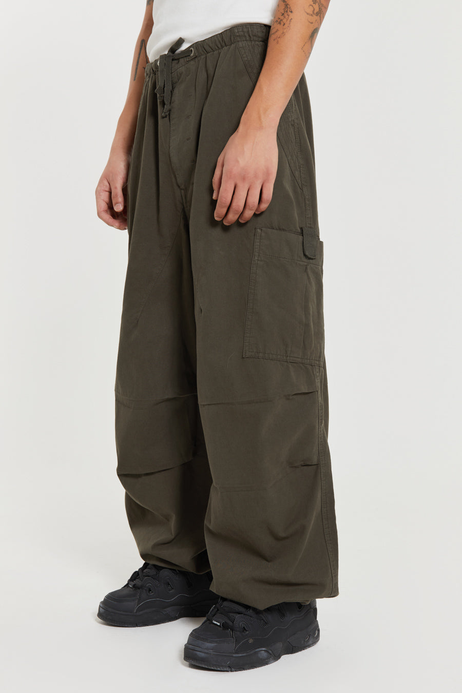 Unisex khaki green oversized fitted parachute style cargo trousers with six pocket styling. 