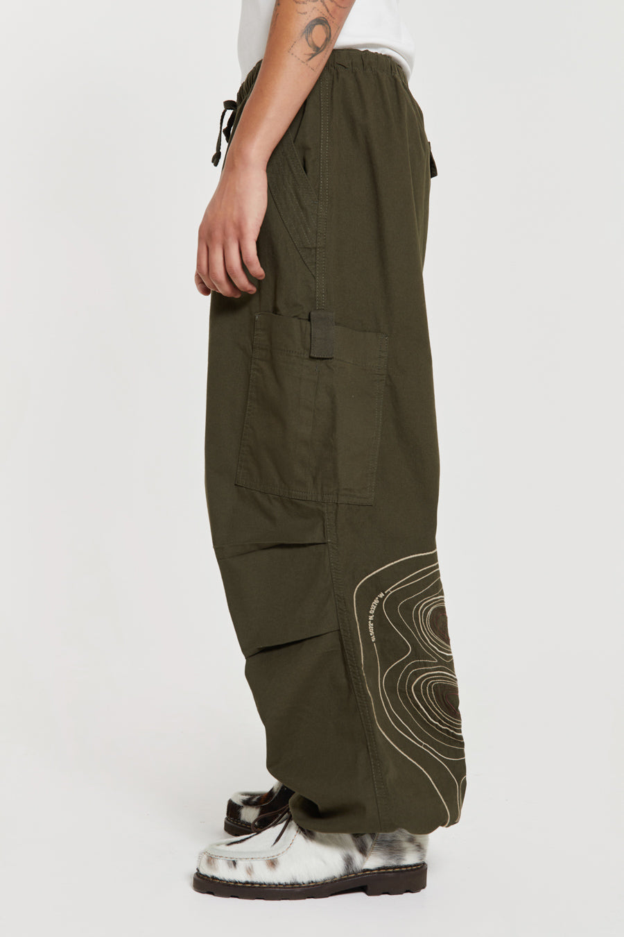 Men's khaki green cargo parachute pants featuring 'Scene' embroidery