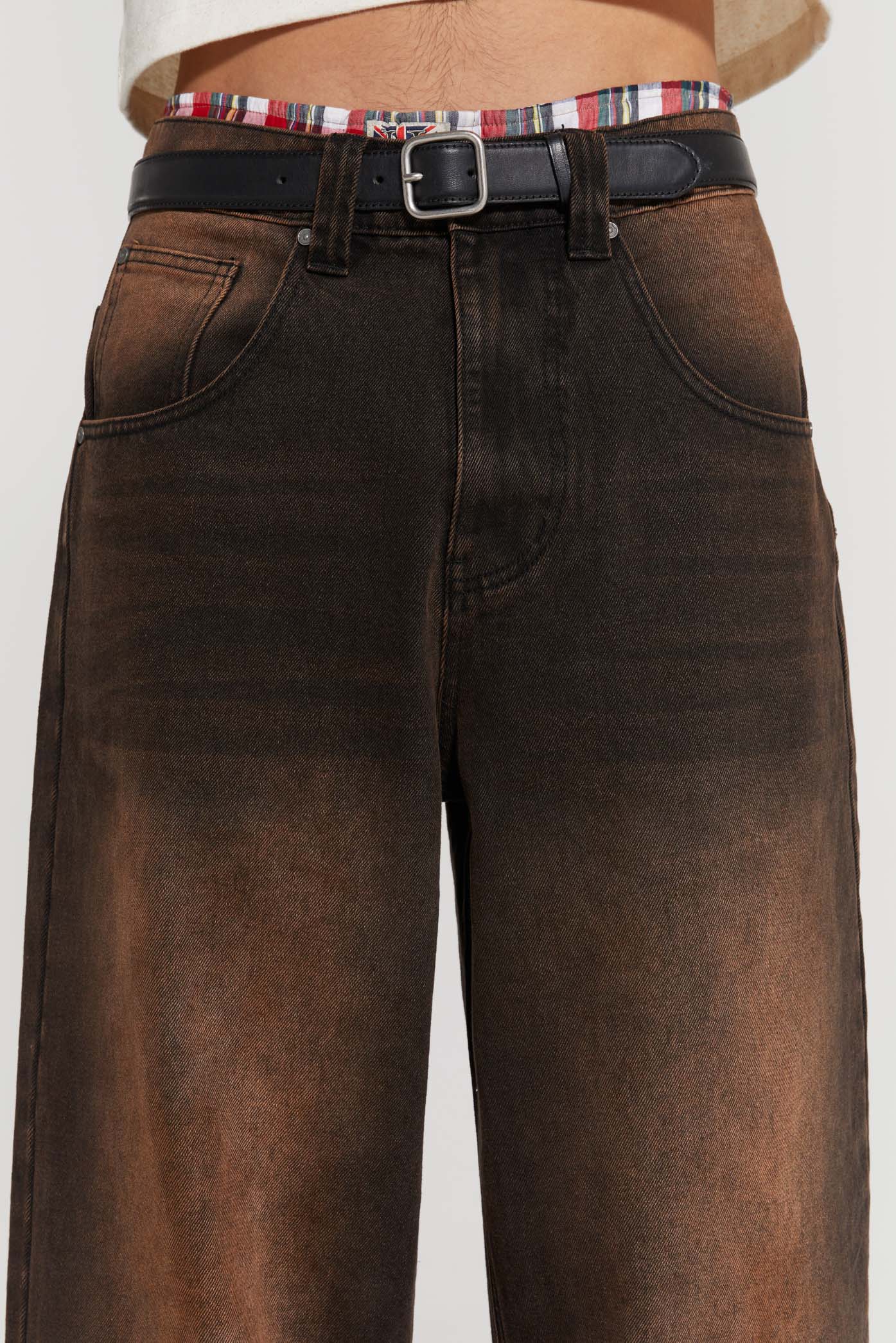 Male wearing vintage brown colossus fit jeans. 