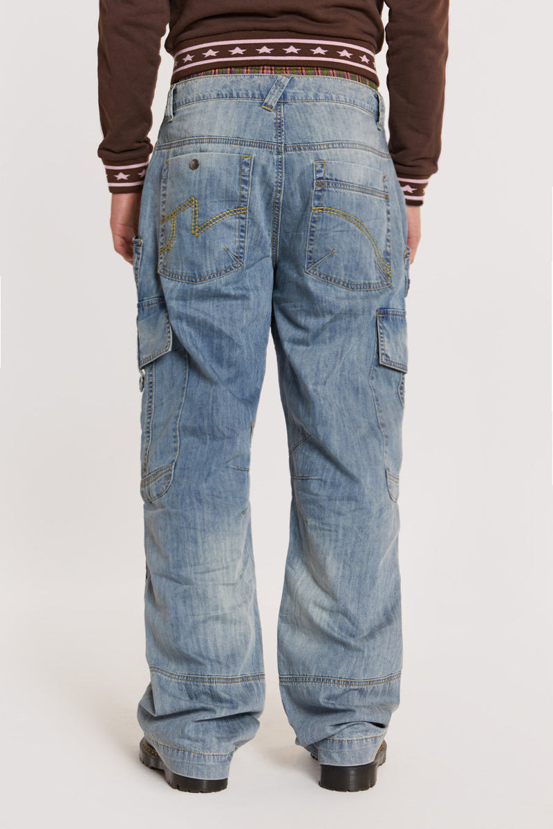 Male model wearing Light Wash Millennium Cargo Jeans. 