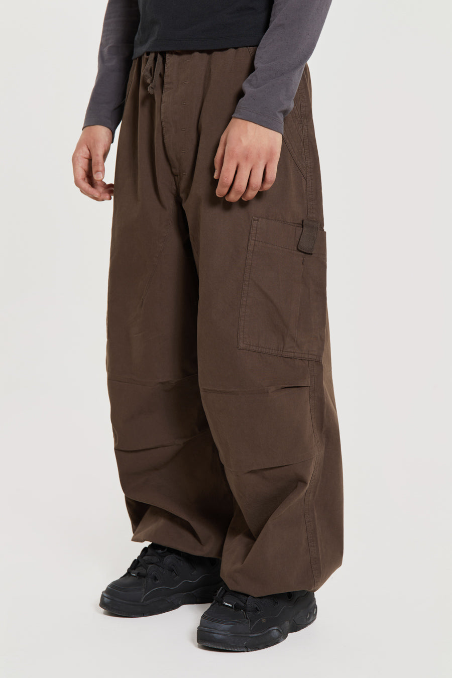 Unisex brown oversized fitted parachute style cargo trousers with six pocket styling. 