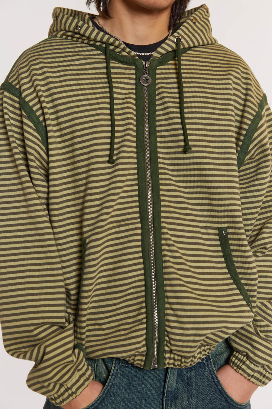 Male model wearing Green Micro Stripe Zip Hoodie . 