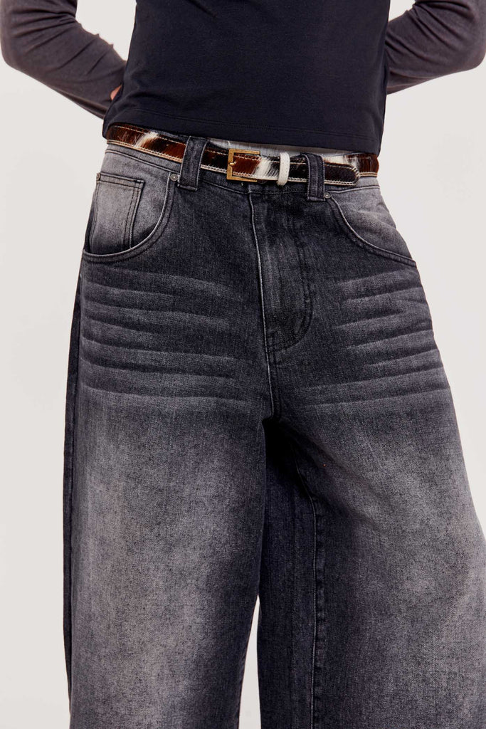 Male wearing washed black colossus fit oversized skate fit denim jeans. 