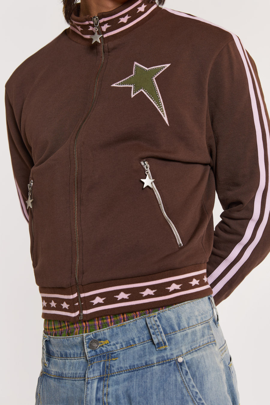 Male model wearing Brown & Pink Track Top with pink stripe detail. 