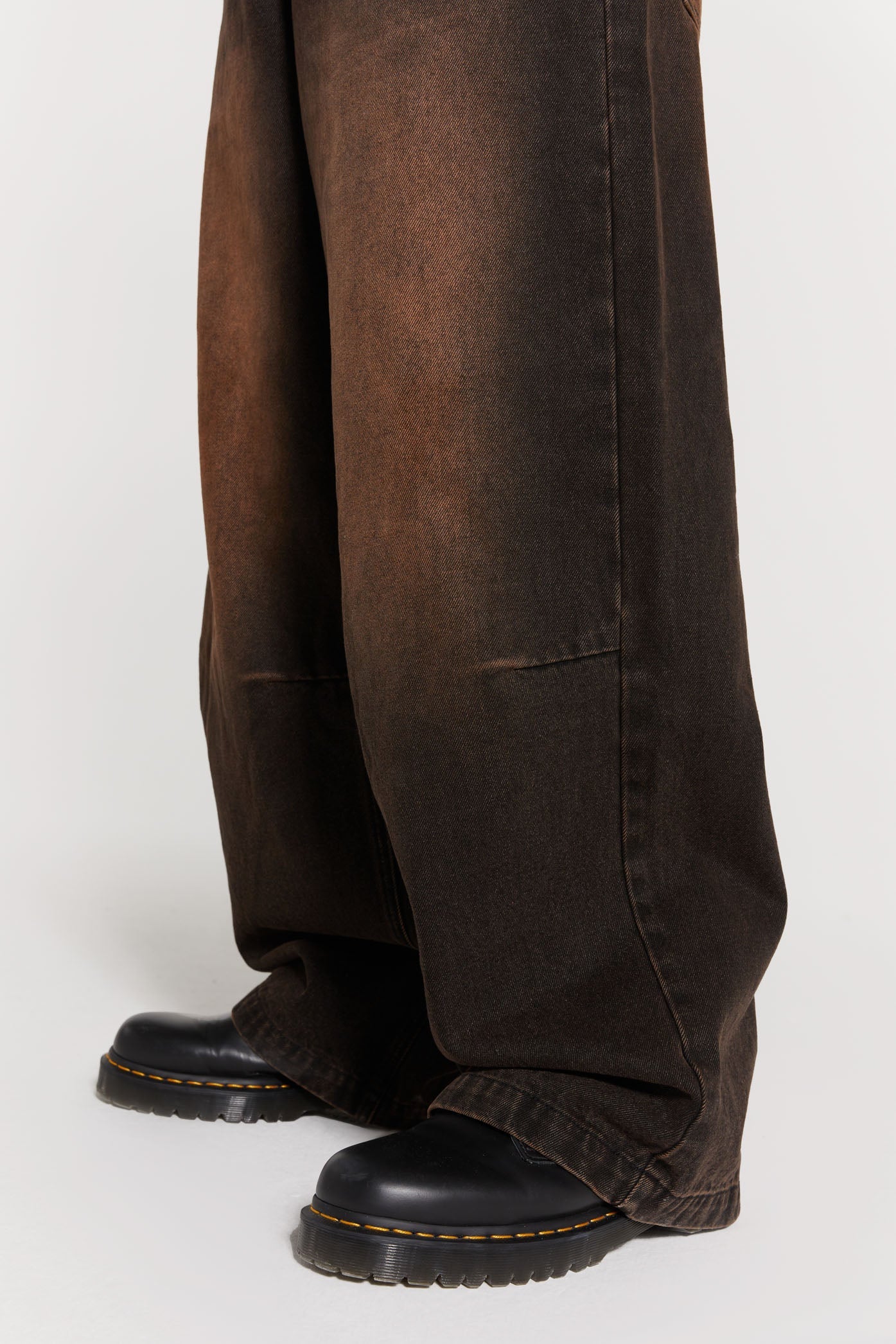 Male wearing vintage brown colossus fit jeans. 