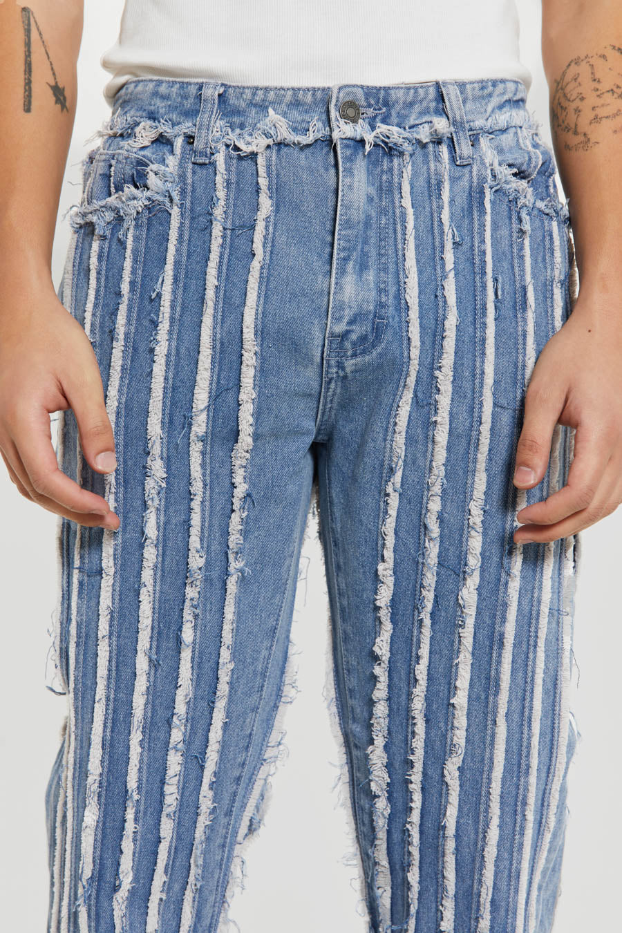 Close up of distressed straight leg blue jeans