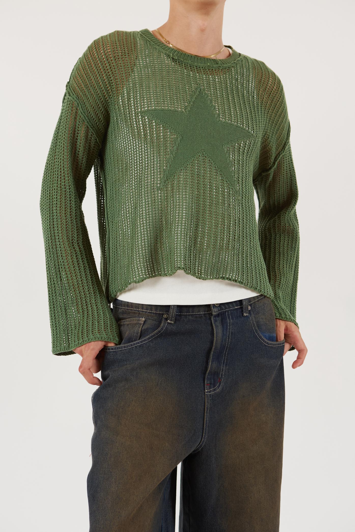 Male wearing Khaki Green Star Loose Knit Jumper.  Styled with blue oversized denim shorts.