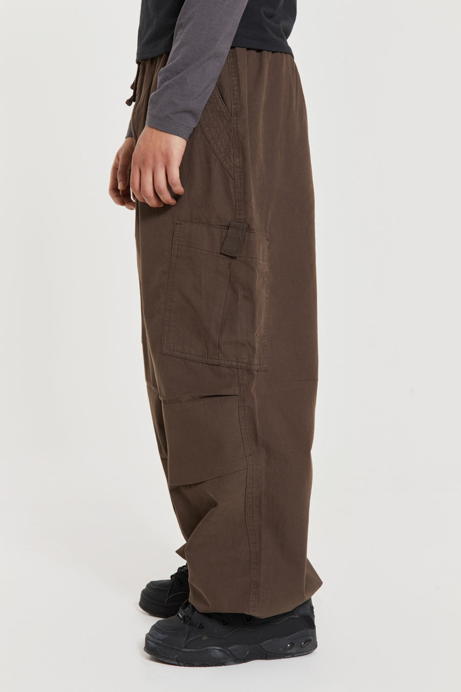 Unisex brown oversized fitted parachute style cargo trousers with six pocket styling. 