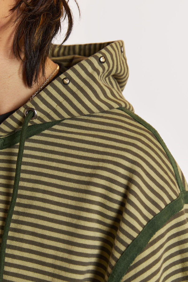 Male model wearing Green Micro Stripe Zip Hoodie . 