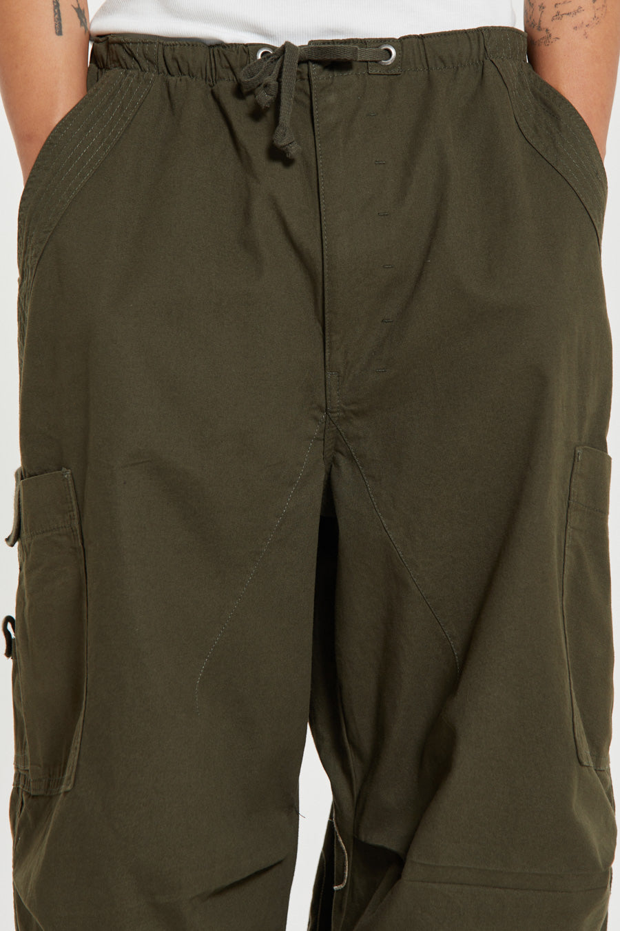 Men's khaki green cargo parachute pants featuring 'Scene' embroidery