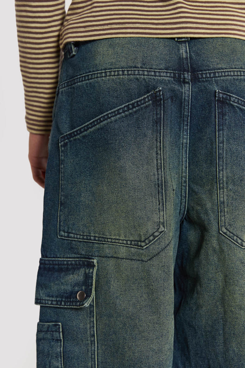 Male model wearing Sandblast Blue Denim Cargo Jeans. 