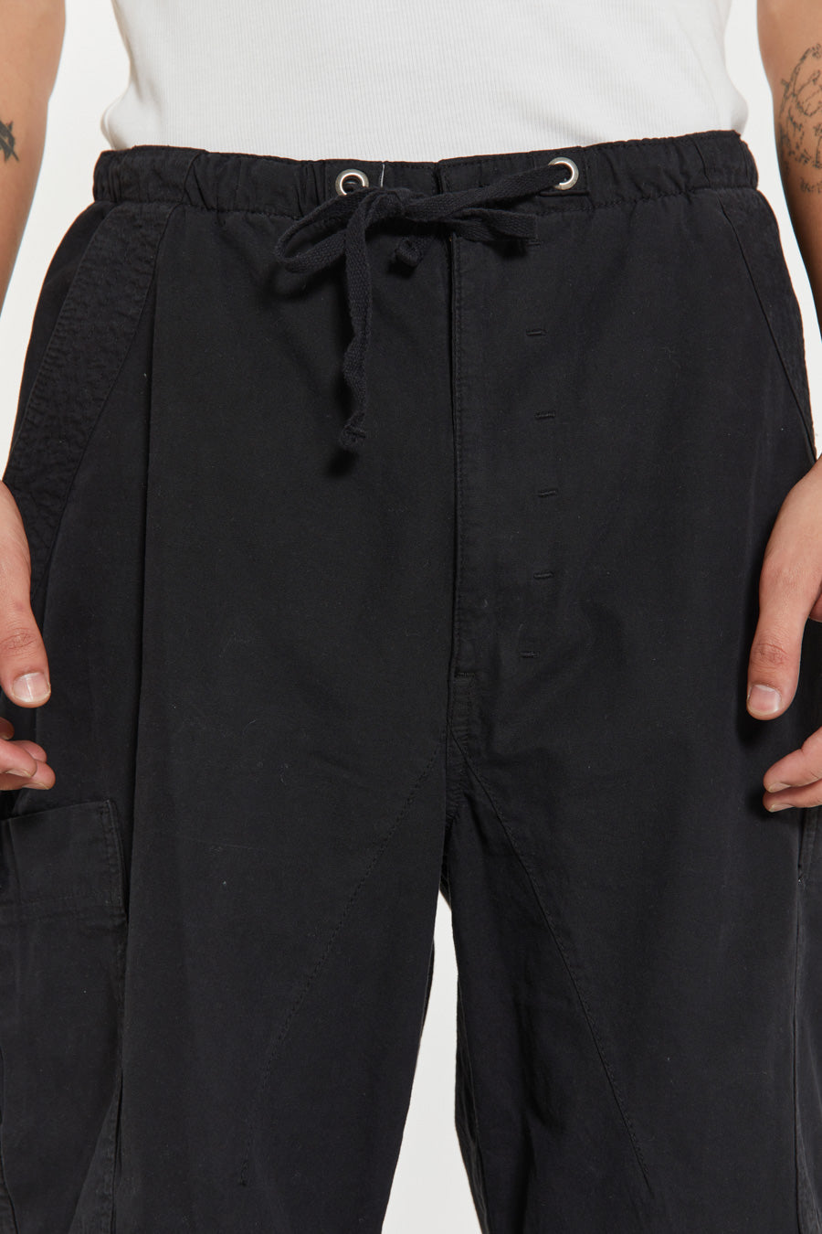 Unisex black oversized fitted parachute style cargo trousers with six pocket styling. 