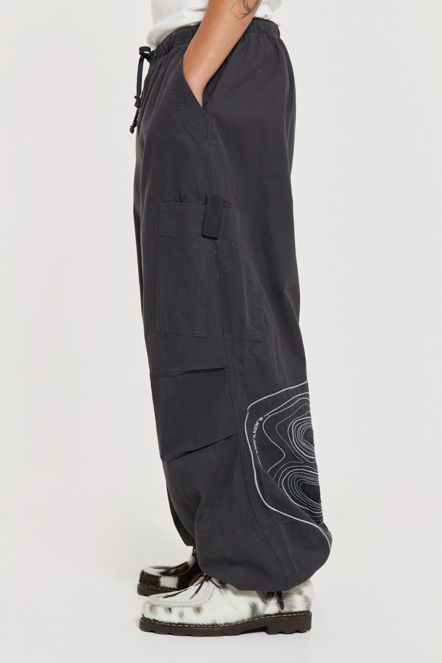 Men's charcoal grey cargo parachute pants featuring 'Scene' embroidery