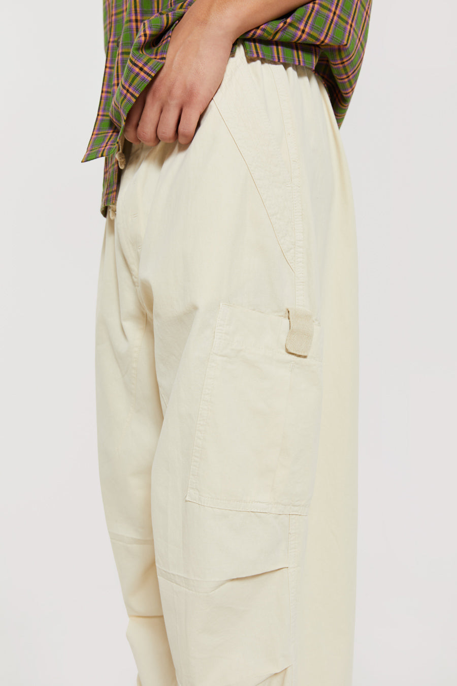 Unisex ecru oversized fitted parachute style cargo trousers with six pocket styling. 