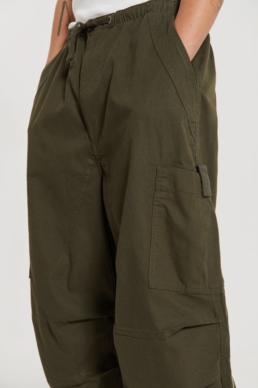 Men's khaki green cargo parachute pants featuring 'Scene' embroidery