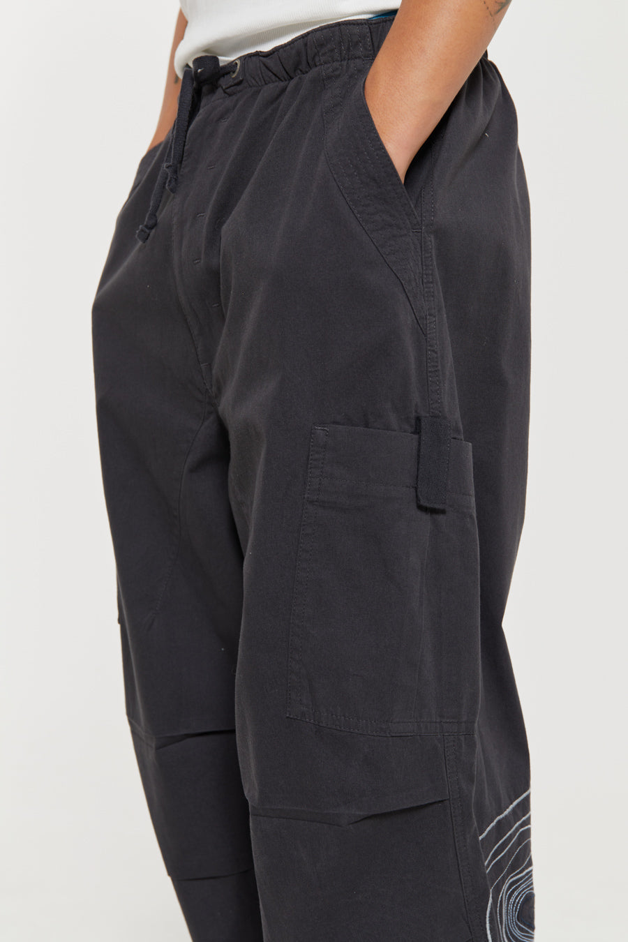 Men's charcoal grey cargo parachute pants featuring 'Scene' embroidery