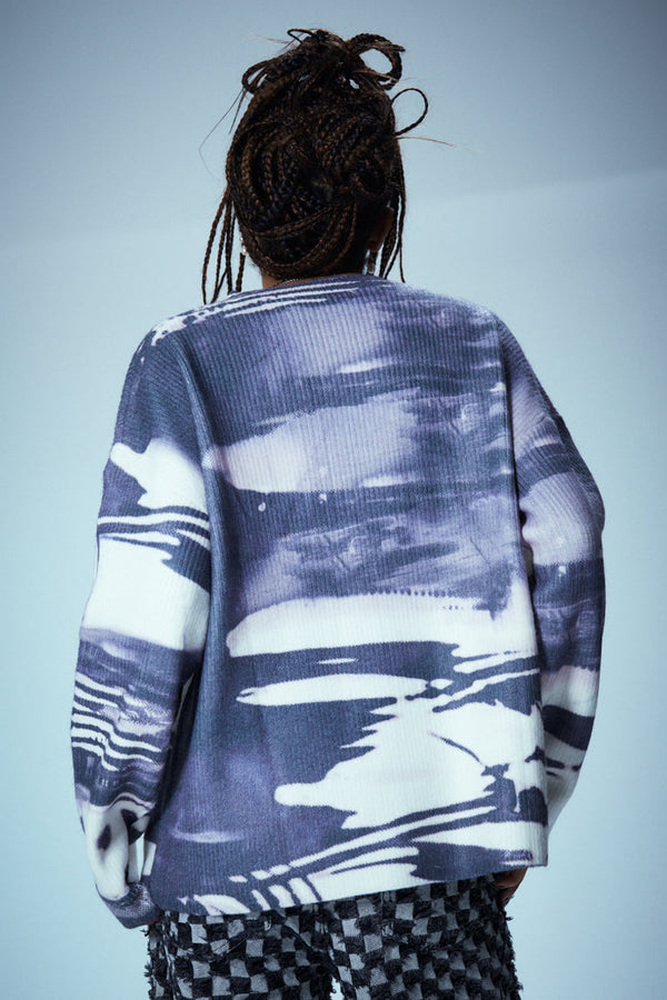 Purple and white eye print long sleeve knitted jumper. Styled with oracle eye multicoloured baggy jeans.