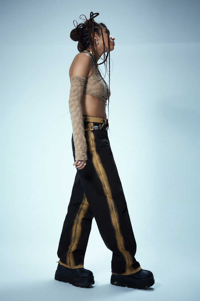 Washed Black Low Rise Baggy Fit Jeans With Burnt Yellow Seams & Hem styled with snake print boots.