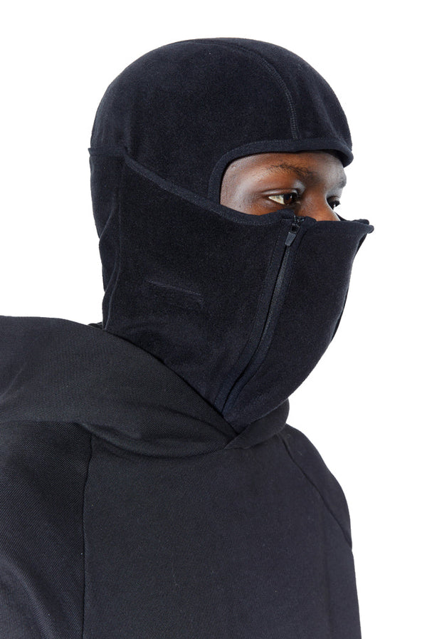 Black polar fleece balaclava with double zip detail. Styled with black hoodie. 