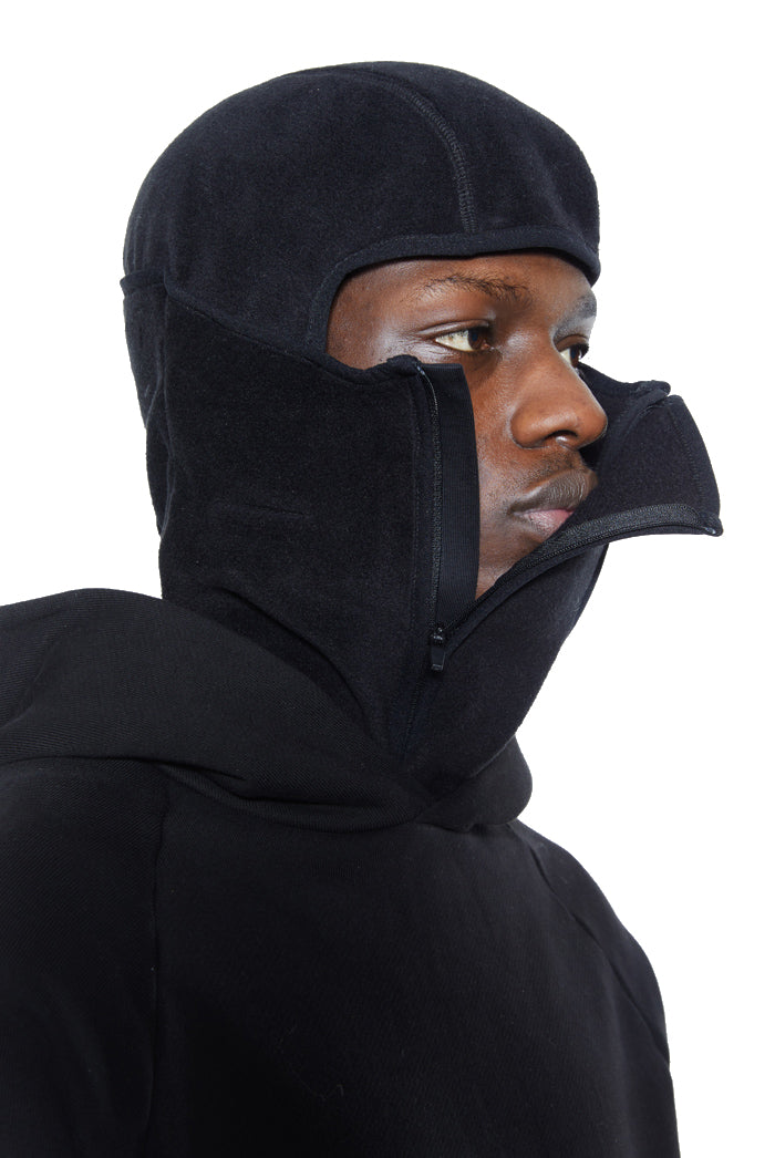 Black polar fleece balaclava with double zip detail. Styled with black hoodie. 