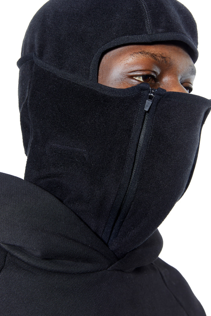 Black polar fleece balaclava with double zip detail. Styled with black hoodie. 