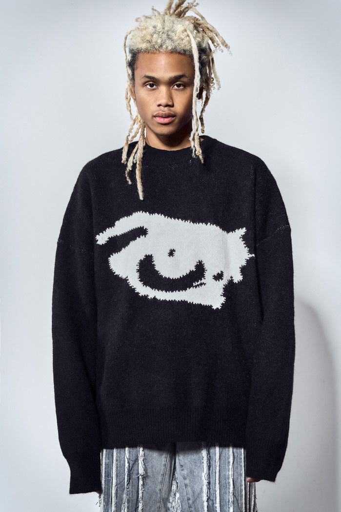 Black knitted long sleeve jumper with white eye print. Styled with the vertigo washed blue denim distressed jeans. 