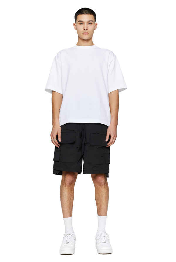Black oversized cargo shorts in relaxed fit with ten pocket styling detail. 
