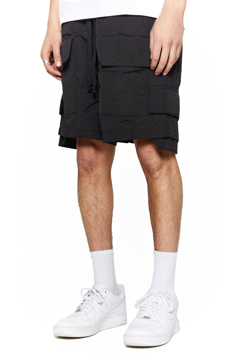 Black oversized cargo shorts in relaxed fit with ten pocket styling detail. 
