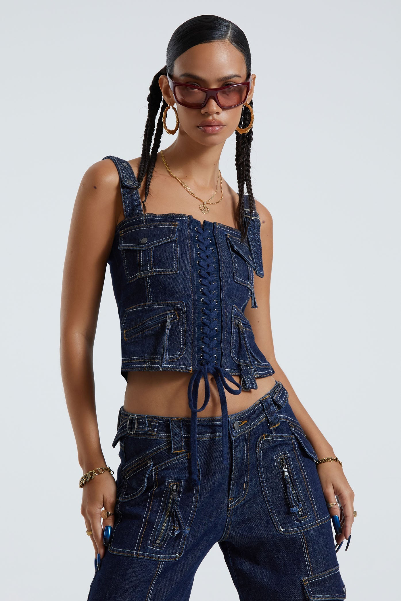 Female wearing indigo blue denim cargo style lace up corset top. Styled with the matching denim cargo trousers.  