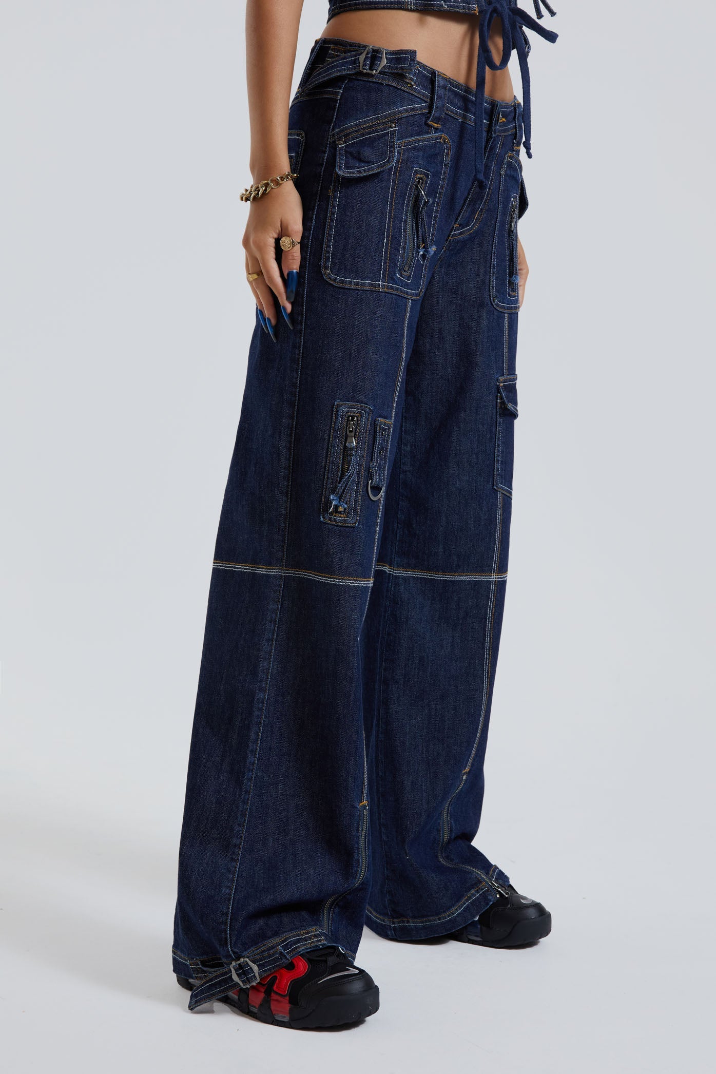 Female wearing blue denim cargo trousers with pocket detail. Styled with the matching denim cargo corset top. 