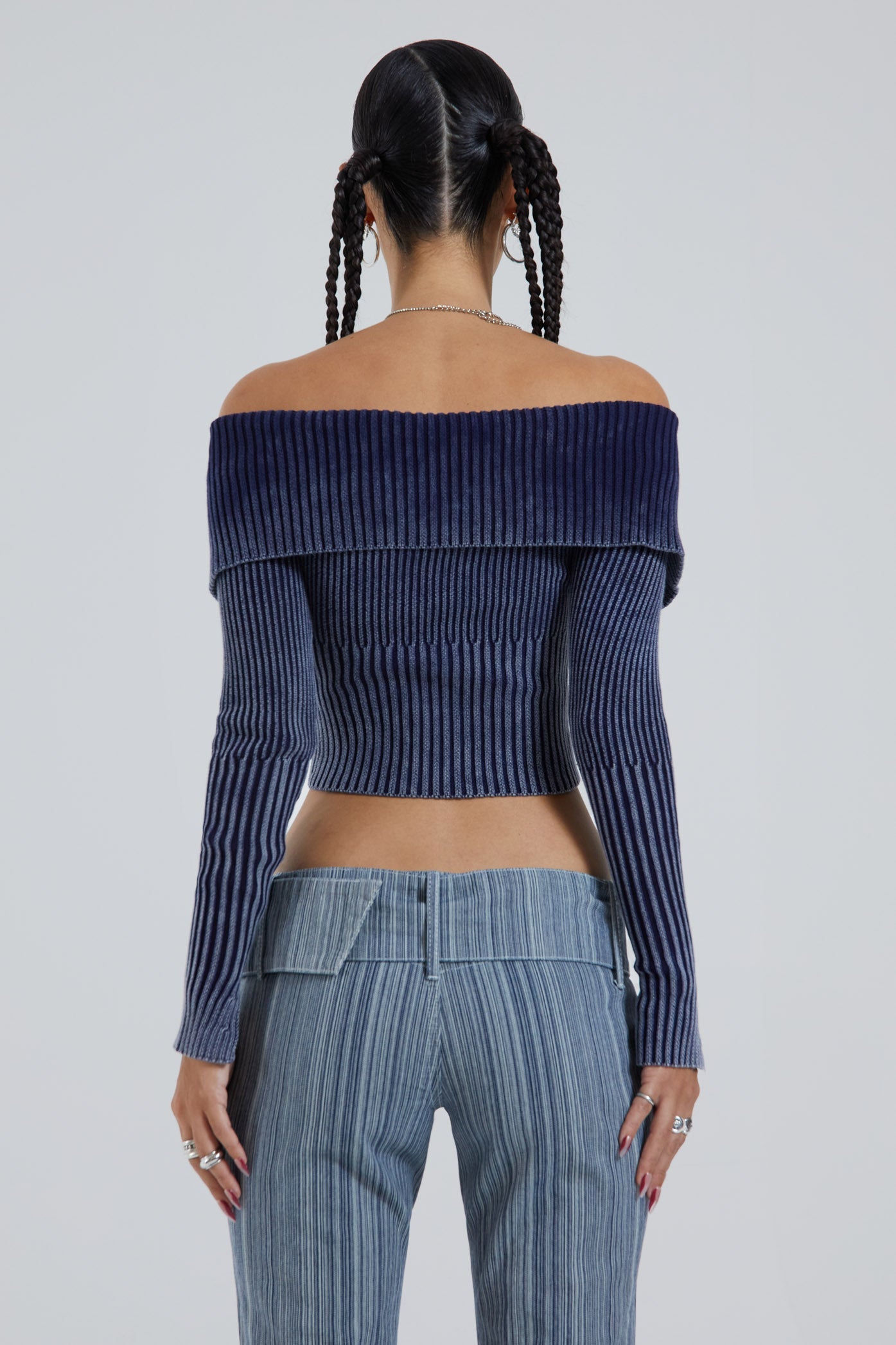 Female wearing blue denim look chunky wide rib knitted long sleeve off the shoulder top. 