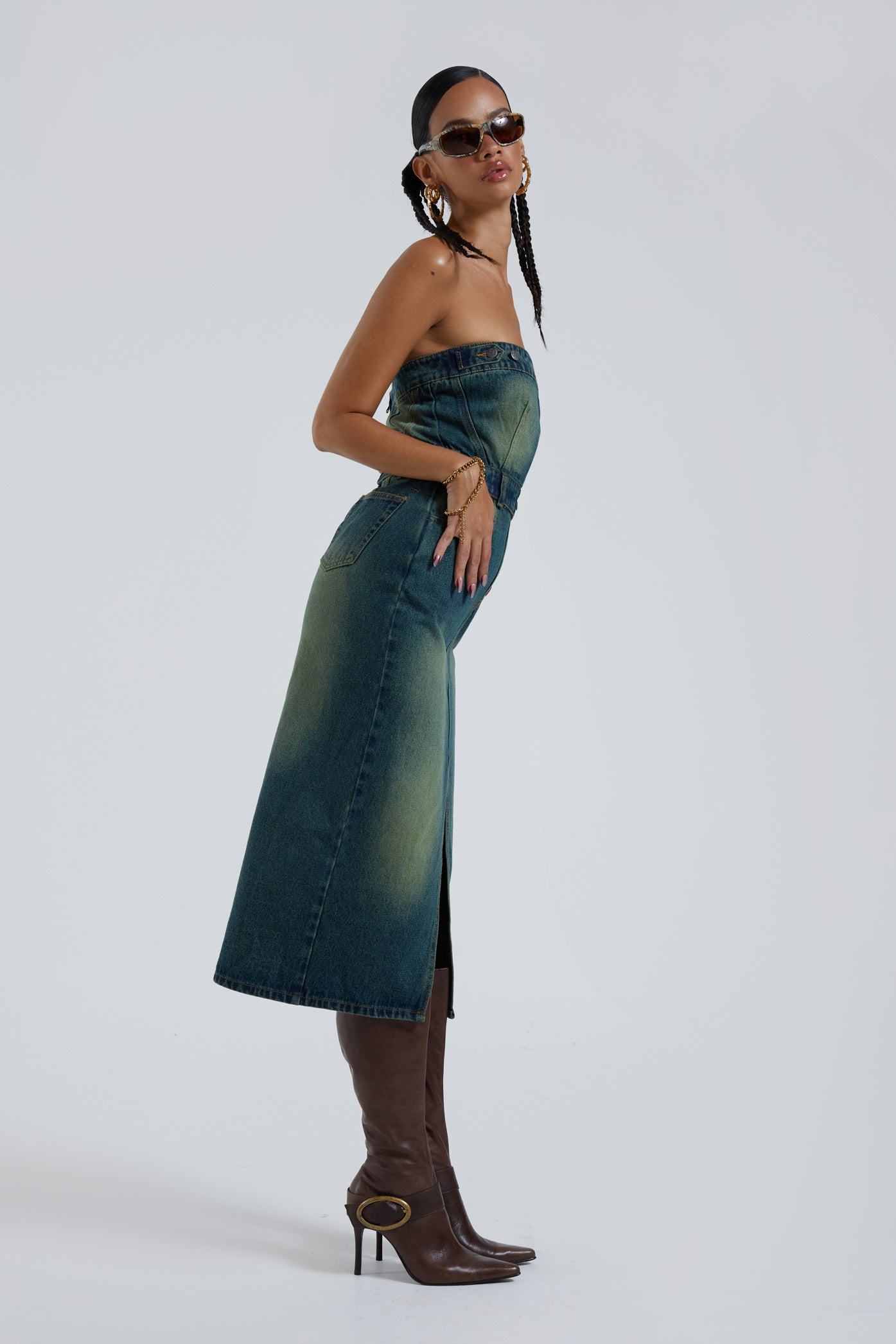 Female wearing blue bandeau denim corset maxi length dress with front split detail. 