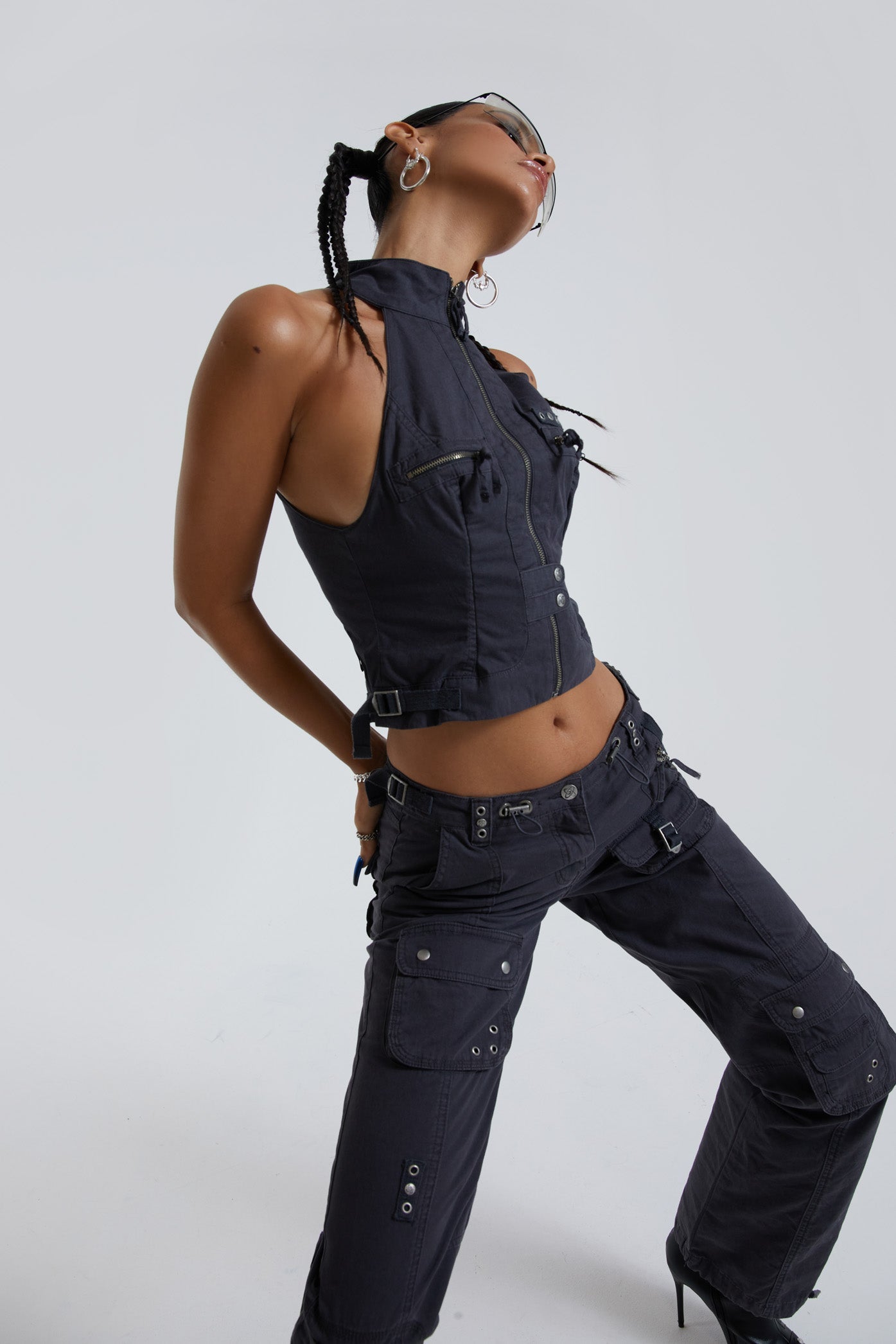 Female wearing vintage grey low rise slim fit cargo trousers. Styled with the matching cargo halterneck top. 