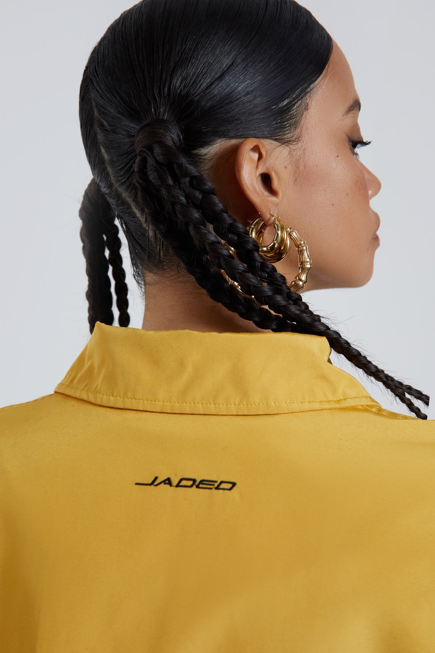 Female wearing yellow oversized track jacket with Jaded branding detail. Styled with the matching track pants. 