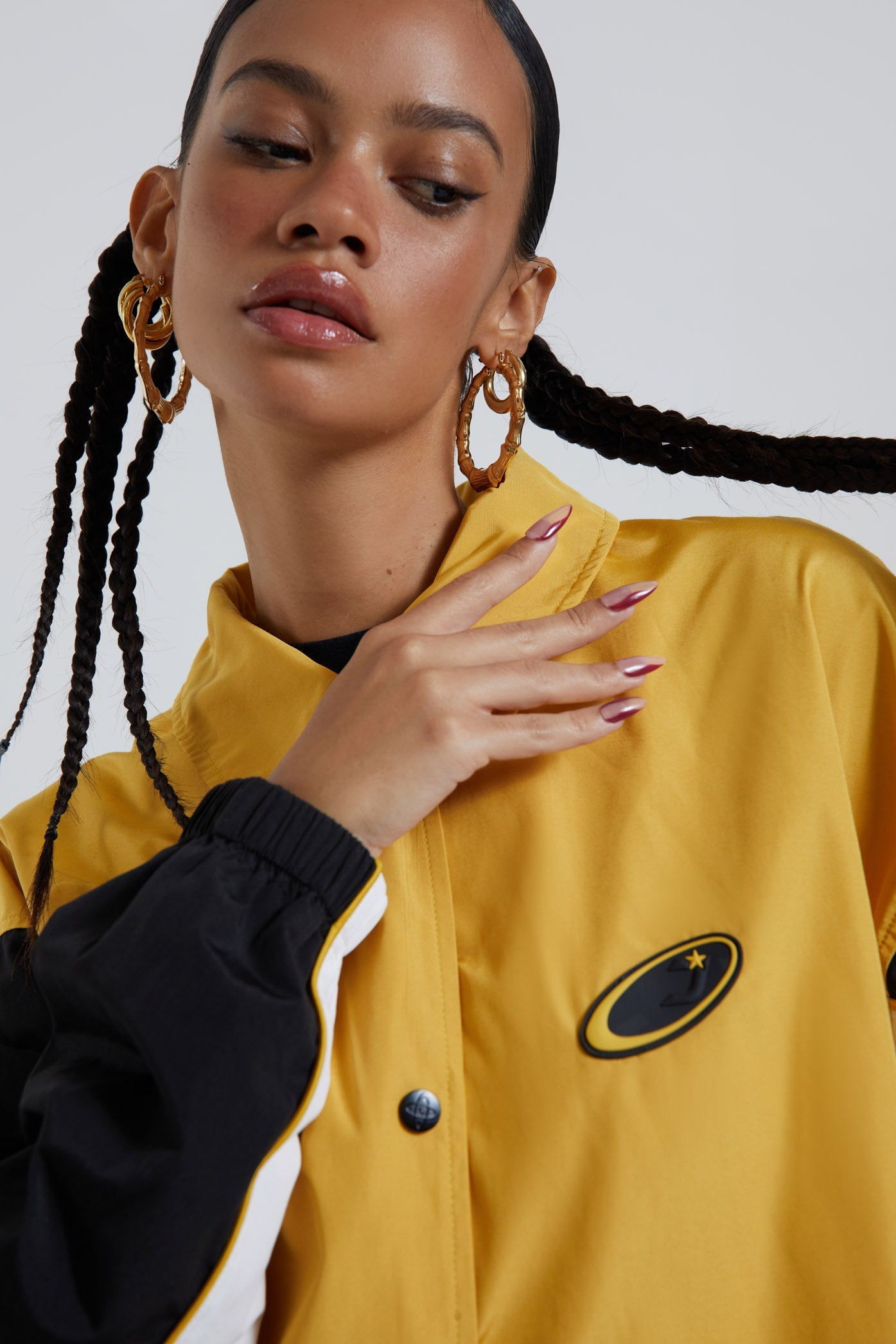 Female wearing yellow oversized track jacket with Jaded branding detail. Styled with the matching track pants. 