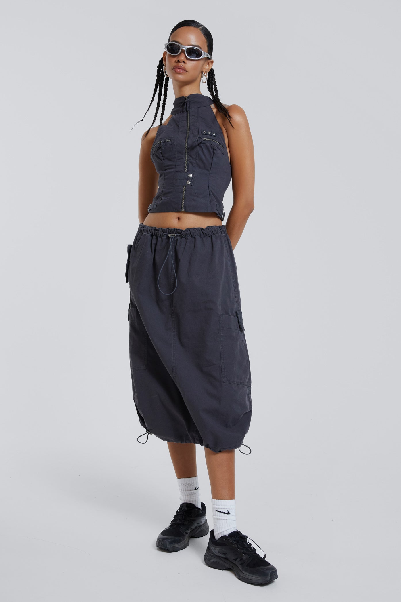 Female wearing grey cargo parachute style maxi skirt. 